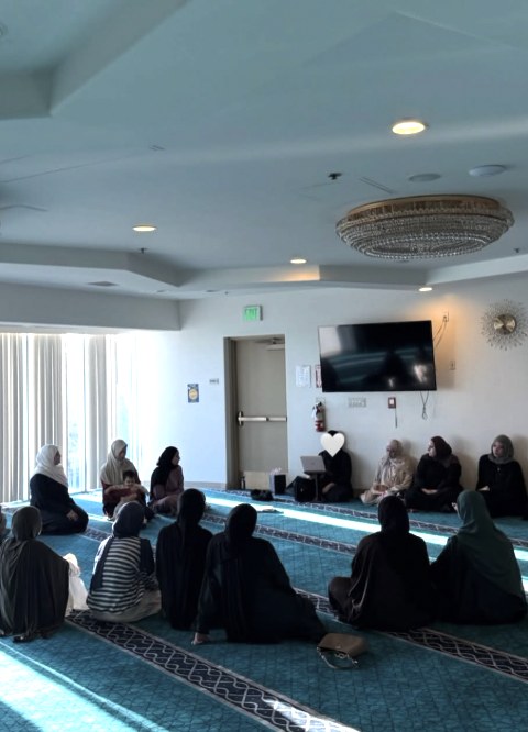 Sisters sitting in a circle in the musalla
